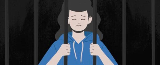 jossa surullinen tyttö kaltereiden takana.