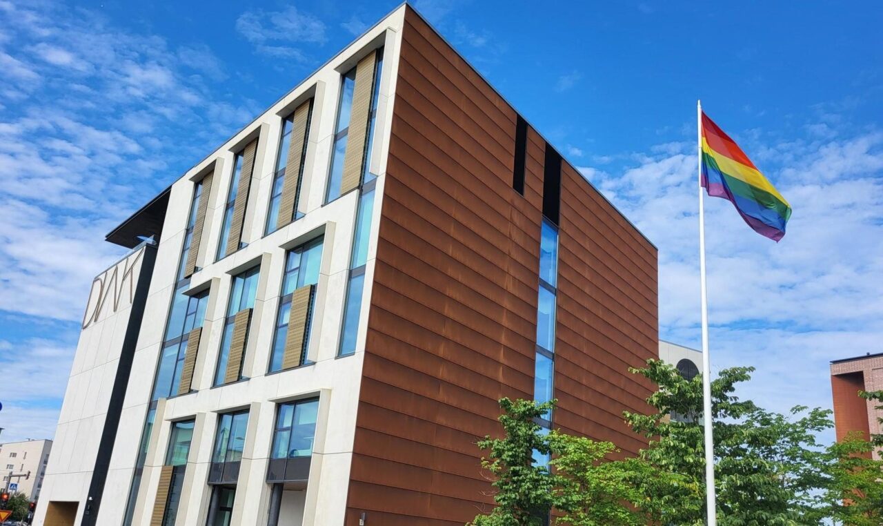 Diak campus in Helsinki and a flag pole with a rainbow flag.