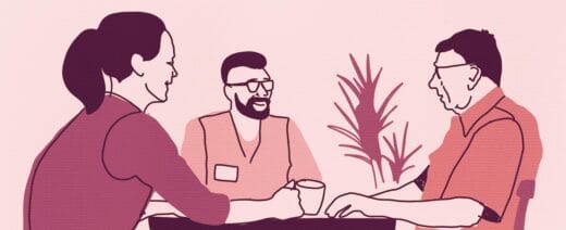 Piirroksessa kolme ihmistä pöydän ympärillä.